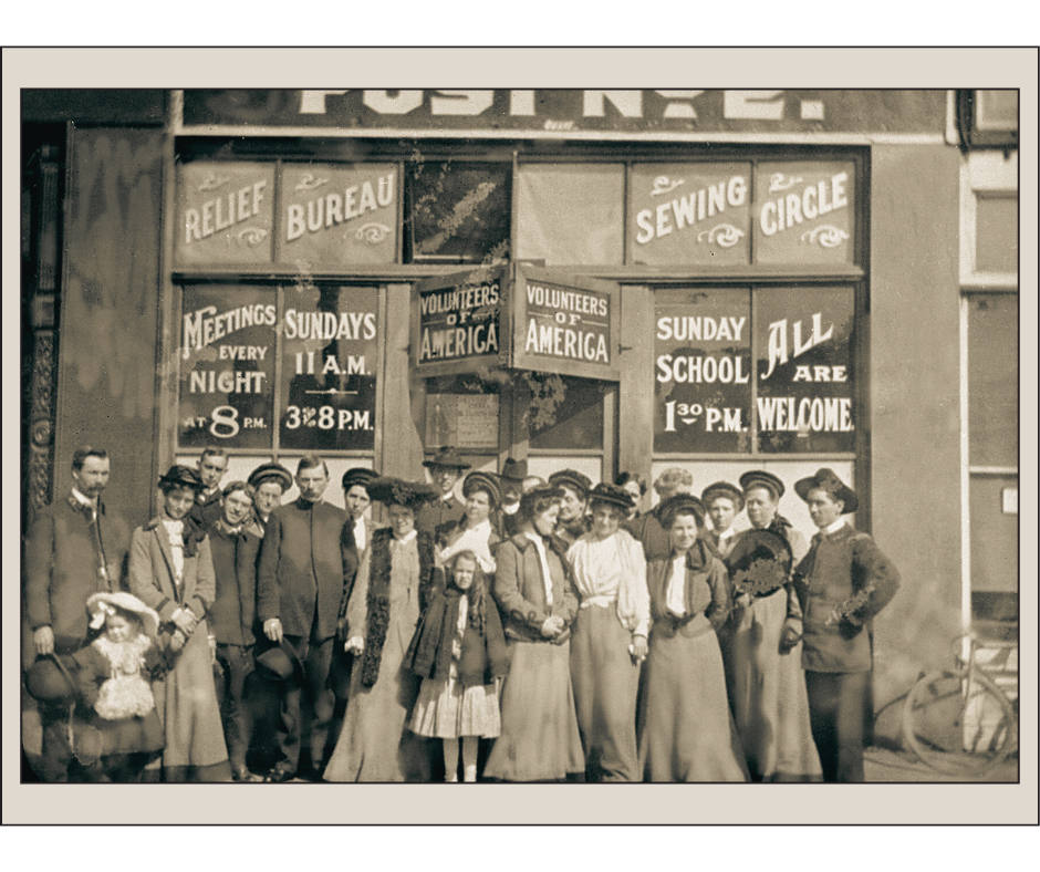 Vintage black and white photo of a group of people standing outside of a VOA building 